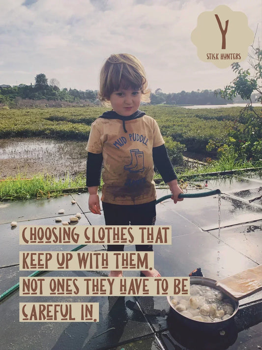kids playing in mud outdoors wearing play clothes